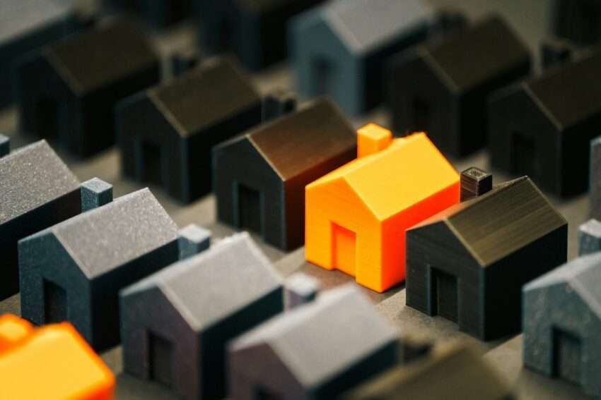 A single, bright house stands out from the rest.